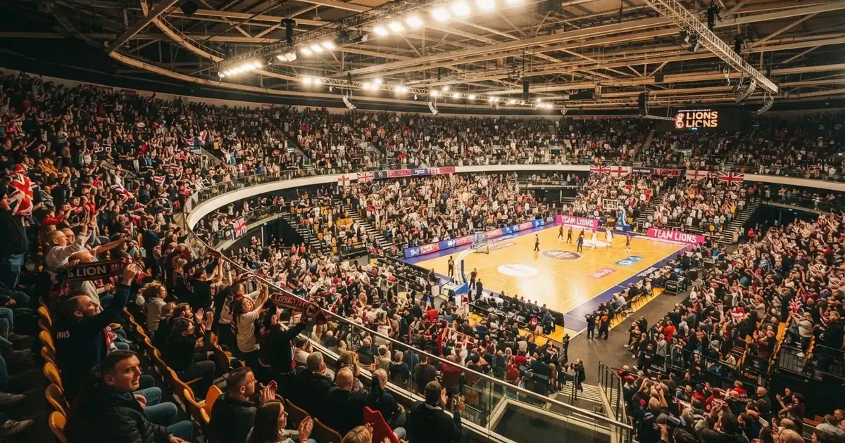 A packed sports hall under floodlights photographed from a long way off