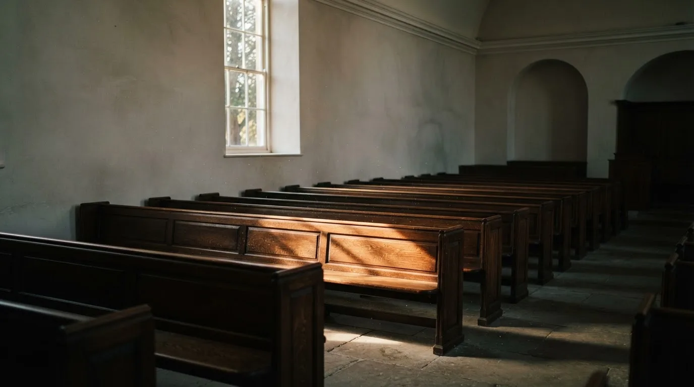 An empty courtroom with wooden benches in morning light
