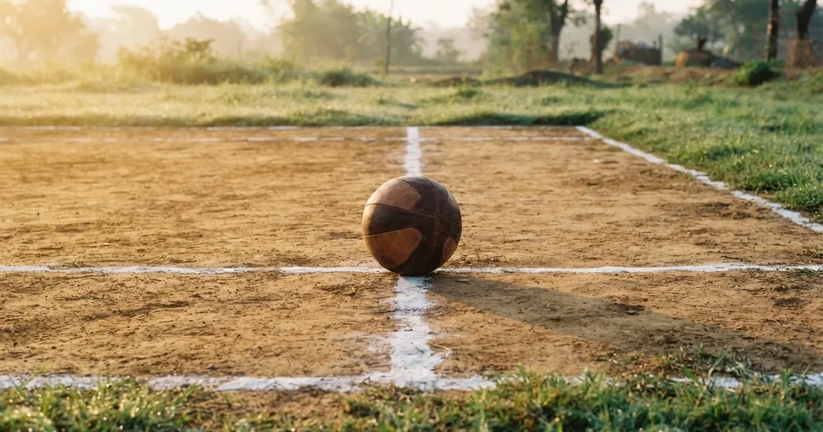A ball on the centre spot of a grass pitch in morning light